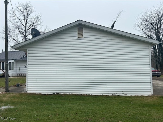 view of home's exterior with a lawn