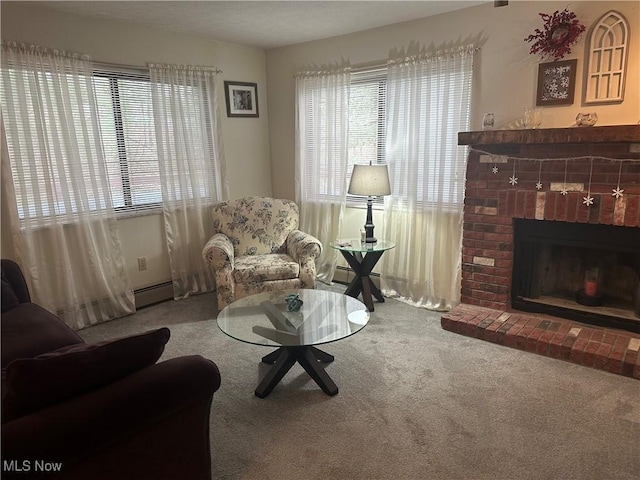 living area featuring a baseboard radiator, carpet floors, and a fireplace