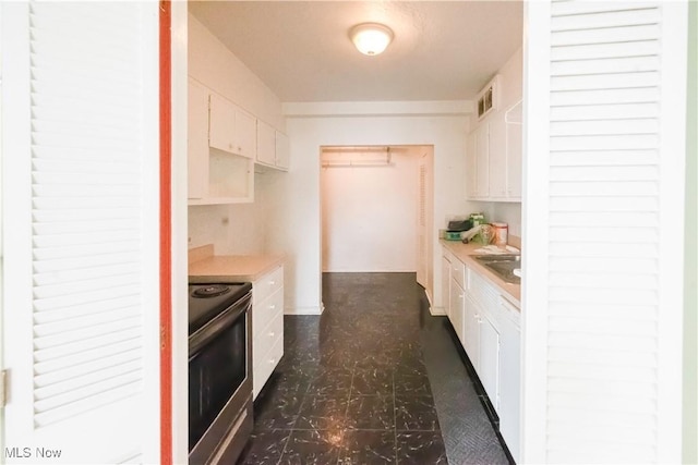 kitchen with white cabinetry and stainless steel range with electric stovetop