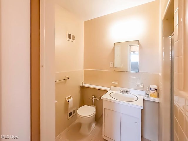 bathroom featuring vanity and toilet