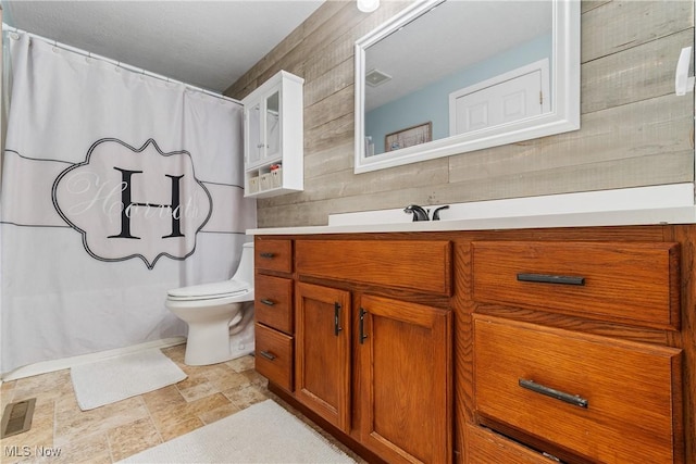 bathroom featuring vanity, toilet, and a shower with shower curtain