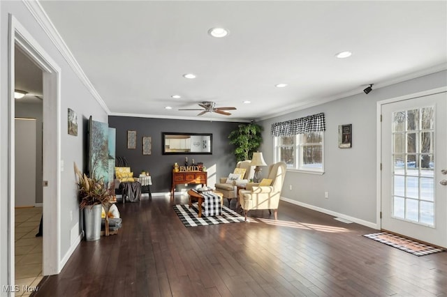 living area with crown molding, dark hardwood / wood-style floors, and ceiling fan