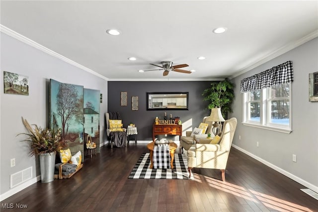 living room with dark wood-type flooring, ornamental molding, and ceiling fan