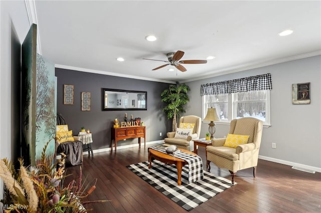 sitting room featuring ornamental molding, dark wood-type flooring, and ceiling fan