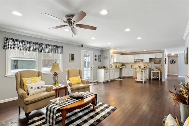 living room with crown molding, ceiling fan, dark hardwood / wood-style flooring, and sink