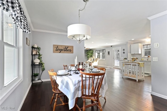 dining space with crown molding and dark hardwood / wood-style flooring