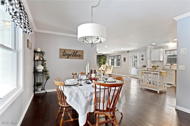 dining room featuring crown molding, dark hardwood / wood-style floors, and a healthy amount of sunlight