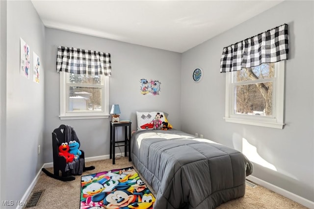 carpeted bedroom with multiple windows