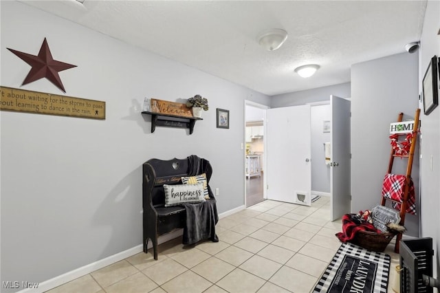 tiled foyer featuring a textured ceiling