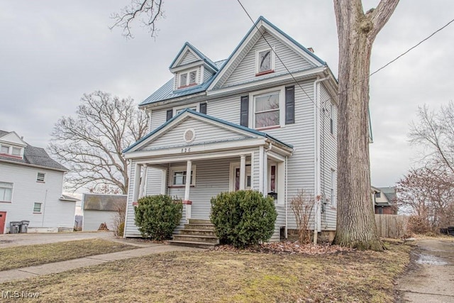 view of front of property with covered porch and a front lawn