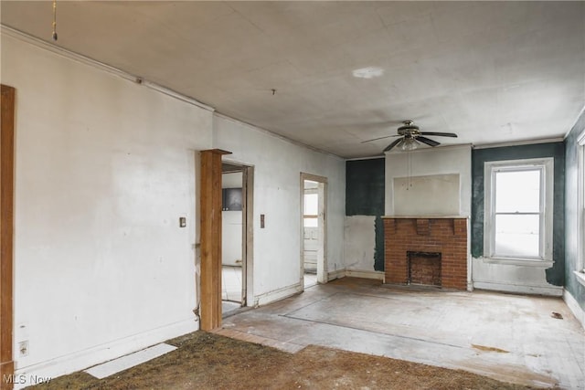 unfurnished living room with a brick fireplace and ceiling fan