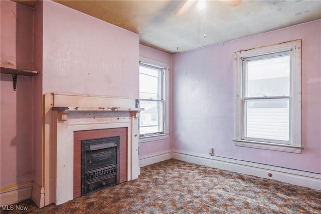 unfurnished living room featuring a fireplace and carpet