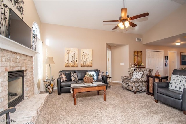 carpeted living room featuring ceiling fan, lofted ceiling, and a fireplace