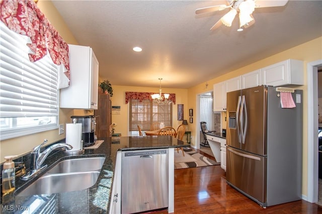 kitchen featuring appliances with stainless steel finishes, sink, white cabinets, hanging light fixtures, and kitchen peninsula