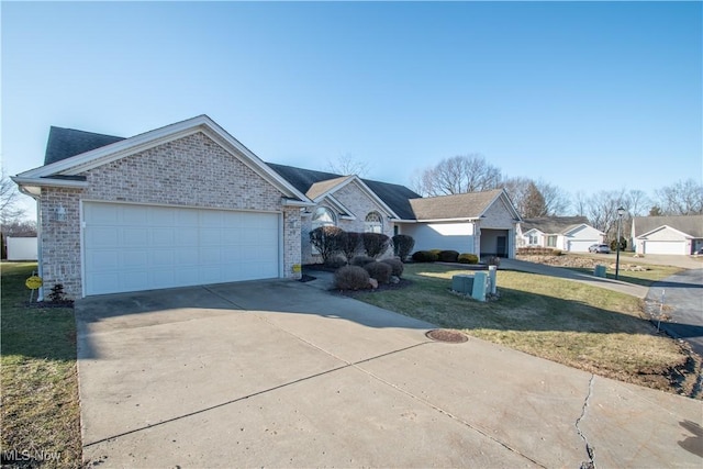 ranch-style house featuring a garage and a front lawn