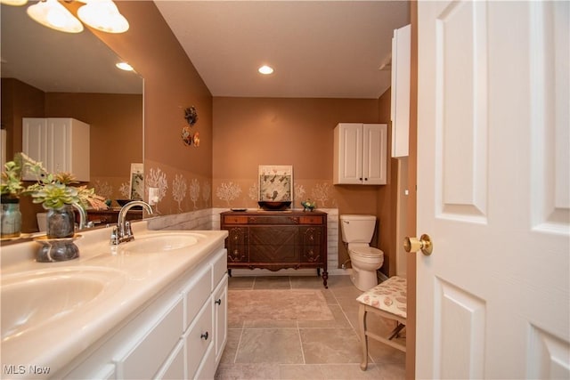 bathroom with vanity, toilet, and tile patterned flooring