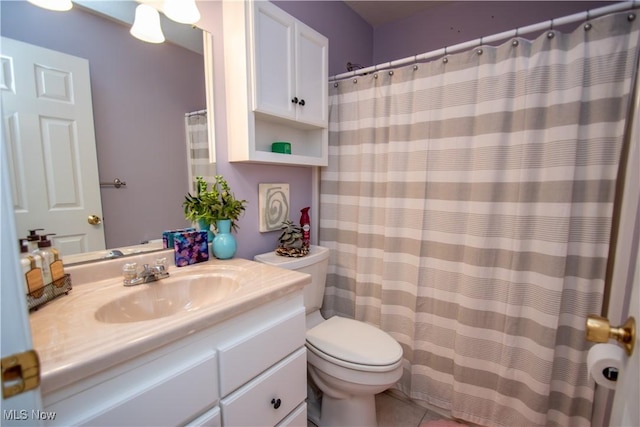 bathroom featuring tile patterned flooring, vanity, and toilet