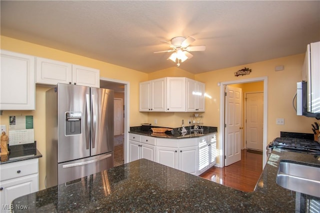 kitchen with white cabinetry, stainless steel refrigerator with ice dispenser, and sink