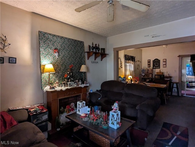 living room with ceiling fan, a textured ceiling, and carpet flooring