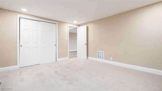 unfurnished bedroom featuring carpet flooring and a closet