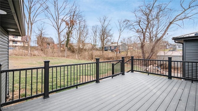 wooden terrace featuring a lawn