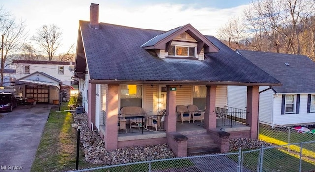 back house at dusk with covered porch