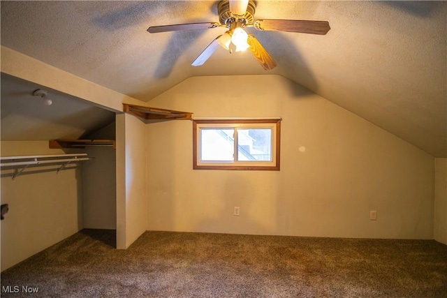 bonus room with ceiling fan, lofted ceiling, carpet floors, and a textured ceiling