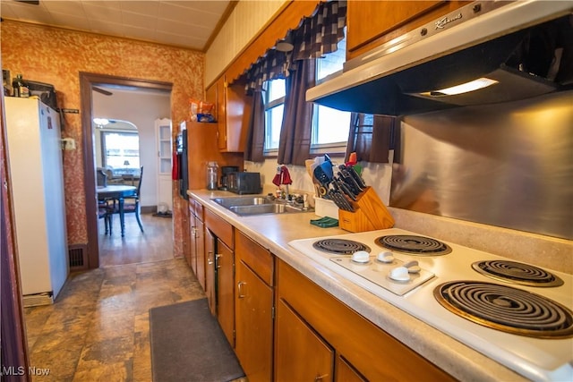 kitchen with extractor fan, sink, and white appliances