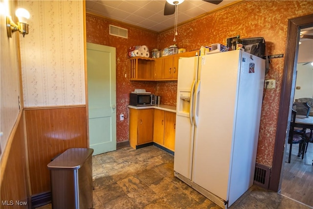 kitchen featuring white fridge with ice dispenser and ceiling fan