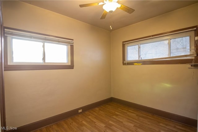 unfurnished room with hardwood / wood-style flooring, ceiling fan, and a wealth of natural light