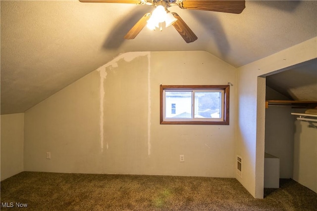 bonus room featuring lofted ceiling, carpet flooring, and a textured ceiling