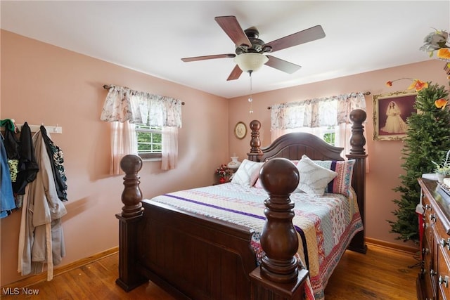 bedroom with dark wood-type flooring and ceiling fan