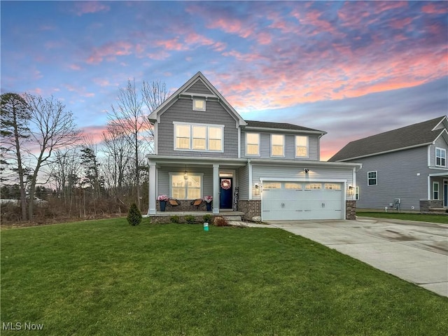 view of front of property with a garage, covered porch, driveway, and a front yard