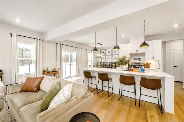 living area featuring recessed lighting and light wood-style floors