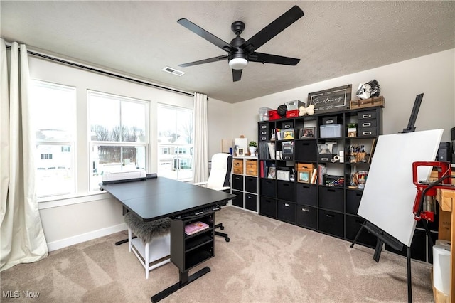 office space with baseboards, carpet, visible vents, and a textured ceiling