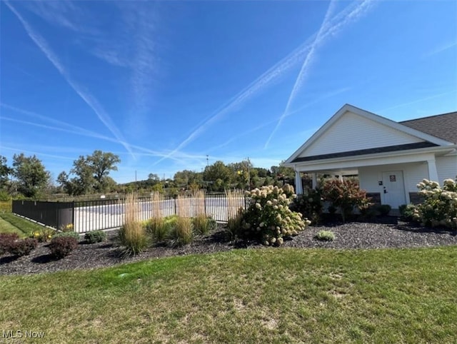 exterior space featuring a yard and fence