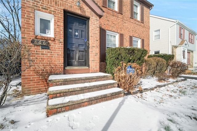 view of snow covered property entrance