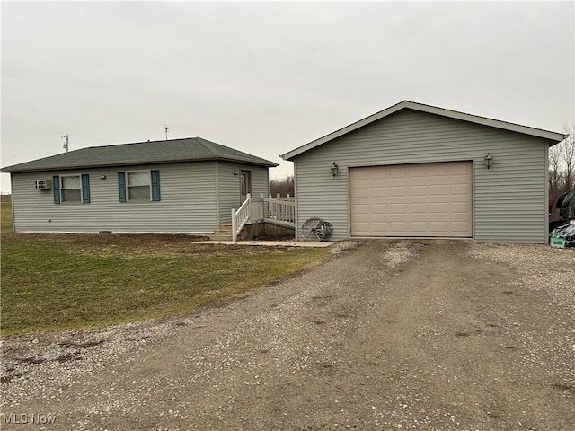 view of front of house featuring a garage, an outdoor structure, and a front yard