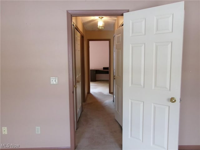 hallway featuring light carpet