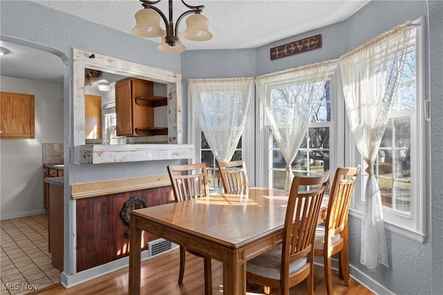 dining space featuring an inviting chandelier