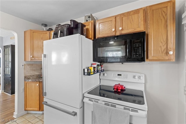 kitchen featuring tasteful backsplash, white appliances, and light tile patterned flooring