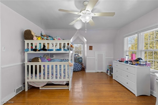 bedroom featuring ceiling fan, lofted ceiling, and light wood-type flooring