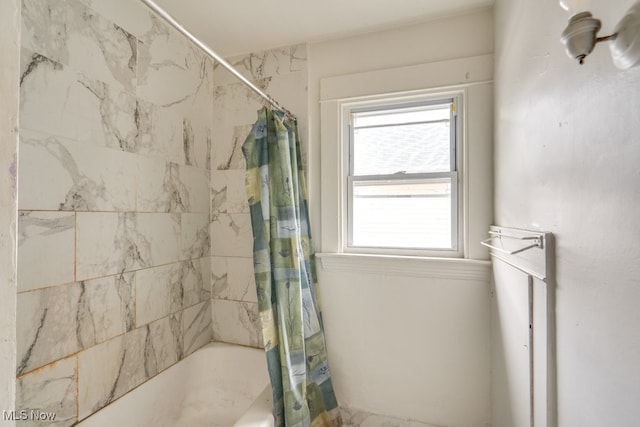 bathroom with shower / bath combination with curtain