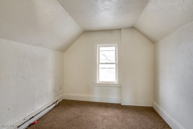 additional living space with vaulted ceiling, carpet flooring, a textured ceiling, and baseboard heating