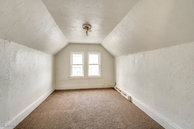 bonus room with lofted ceiling, a baseboard radiator, a textured ceiling, and carpet flooring