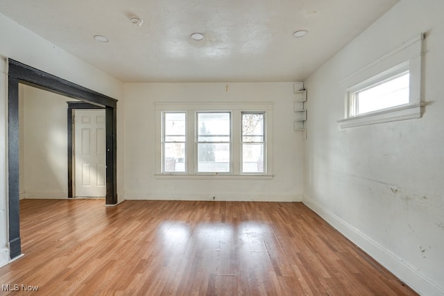 unfurnished room with light hardwood / wood-style flooring and a healthy amount of sunlight