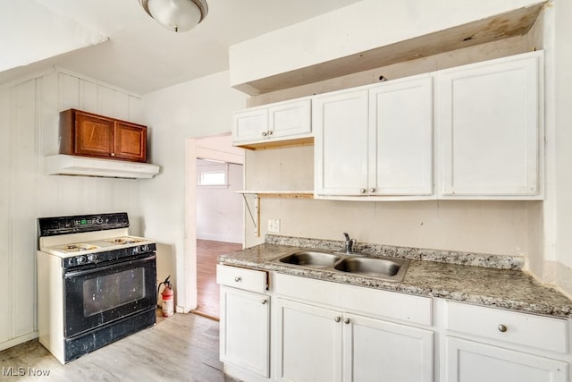 kitchen with white cabinetry, sink, and range