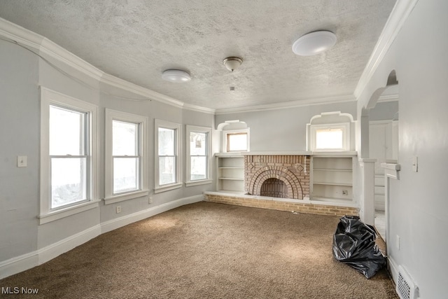 unfurnished living room featuring crown molding, a fireplace, a wealth of natural light, and carpet floors