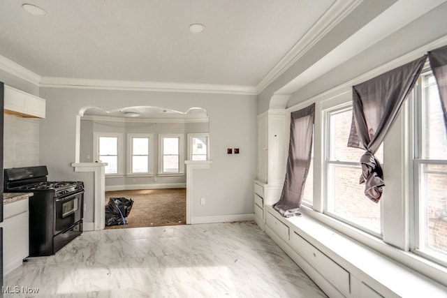 kitchen with crown molding, black range with gas stovetop, and white cabinets