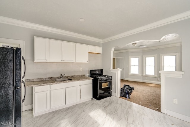 kitchen with sink, white cabinets, light colored carpet, black appliances, and crown molding